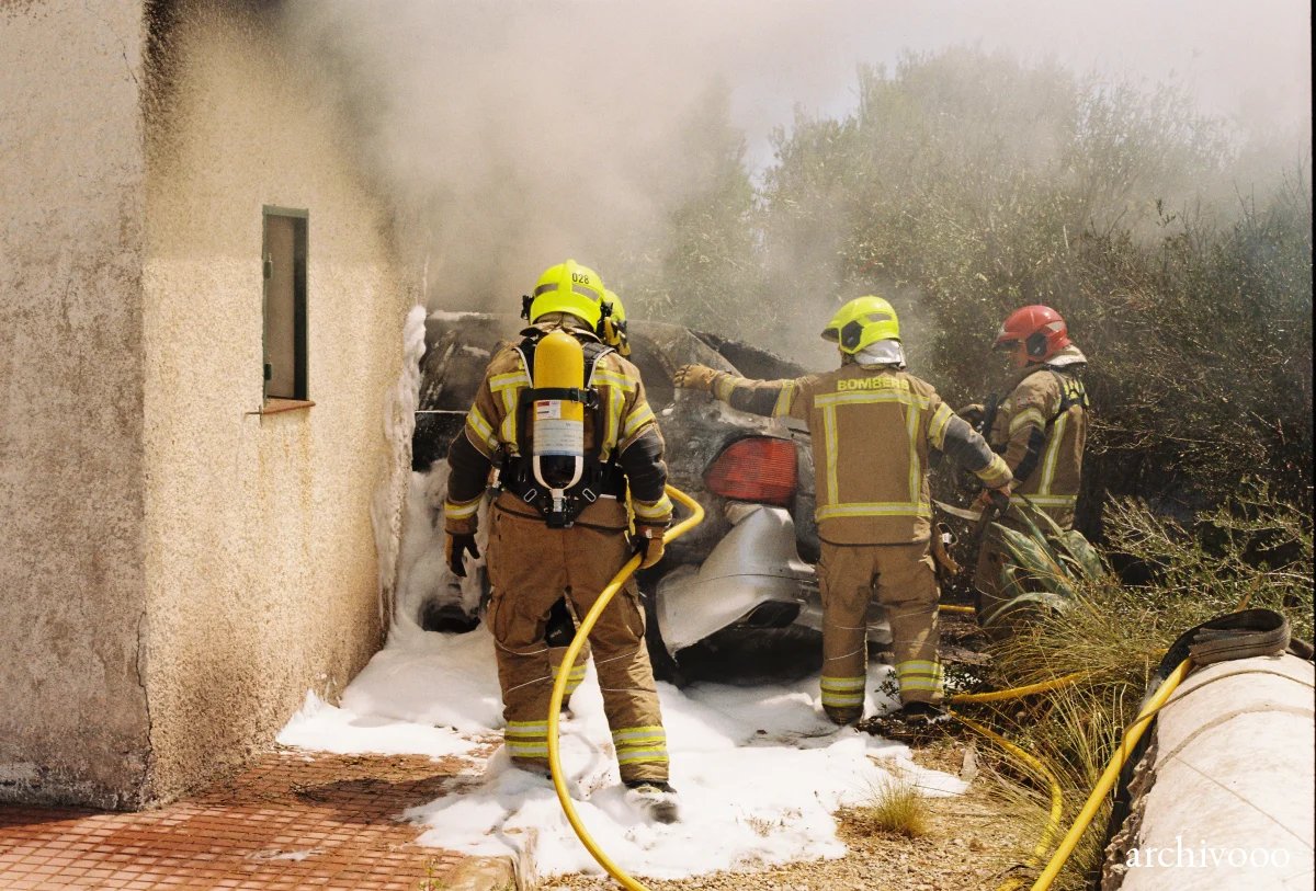 Firemen and burning Porsche